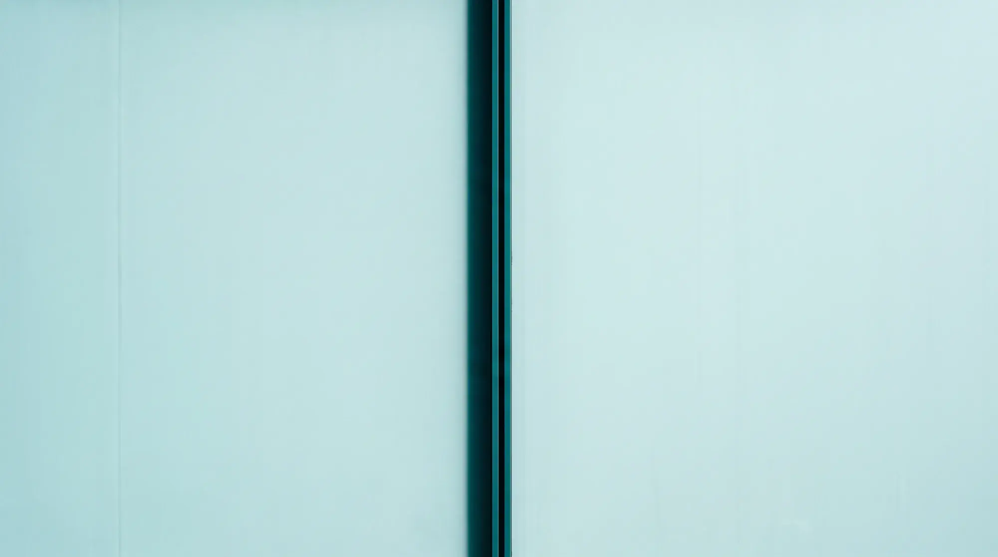 Two pale panels meeting at a single dark vertical seam