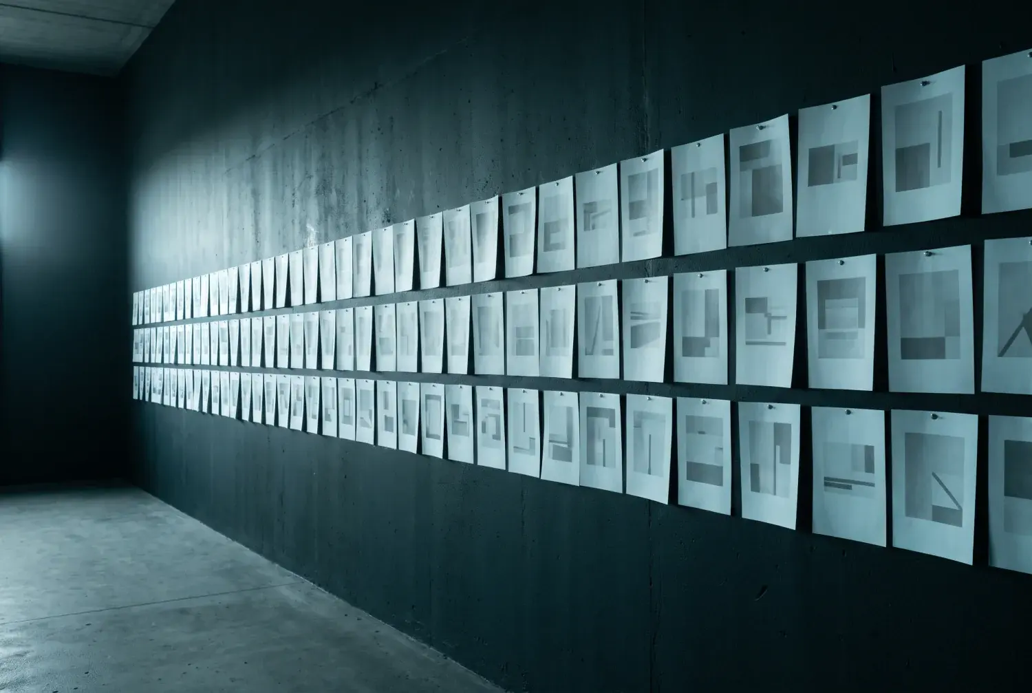 Screen layouts pinned across the studio wall